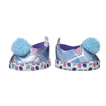Your furry friend can put their best paw forward in this sweet pair of Kabu sneakers! These silver shoes have blue poms and a cotton candy print on the soles. Shop online or in store at Build-A-Bear Workshop!